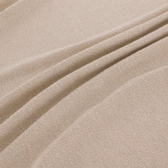 Pale chalk-beige finely textured fabric arranged in soft diagonal folds