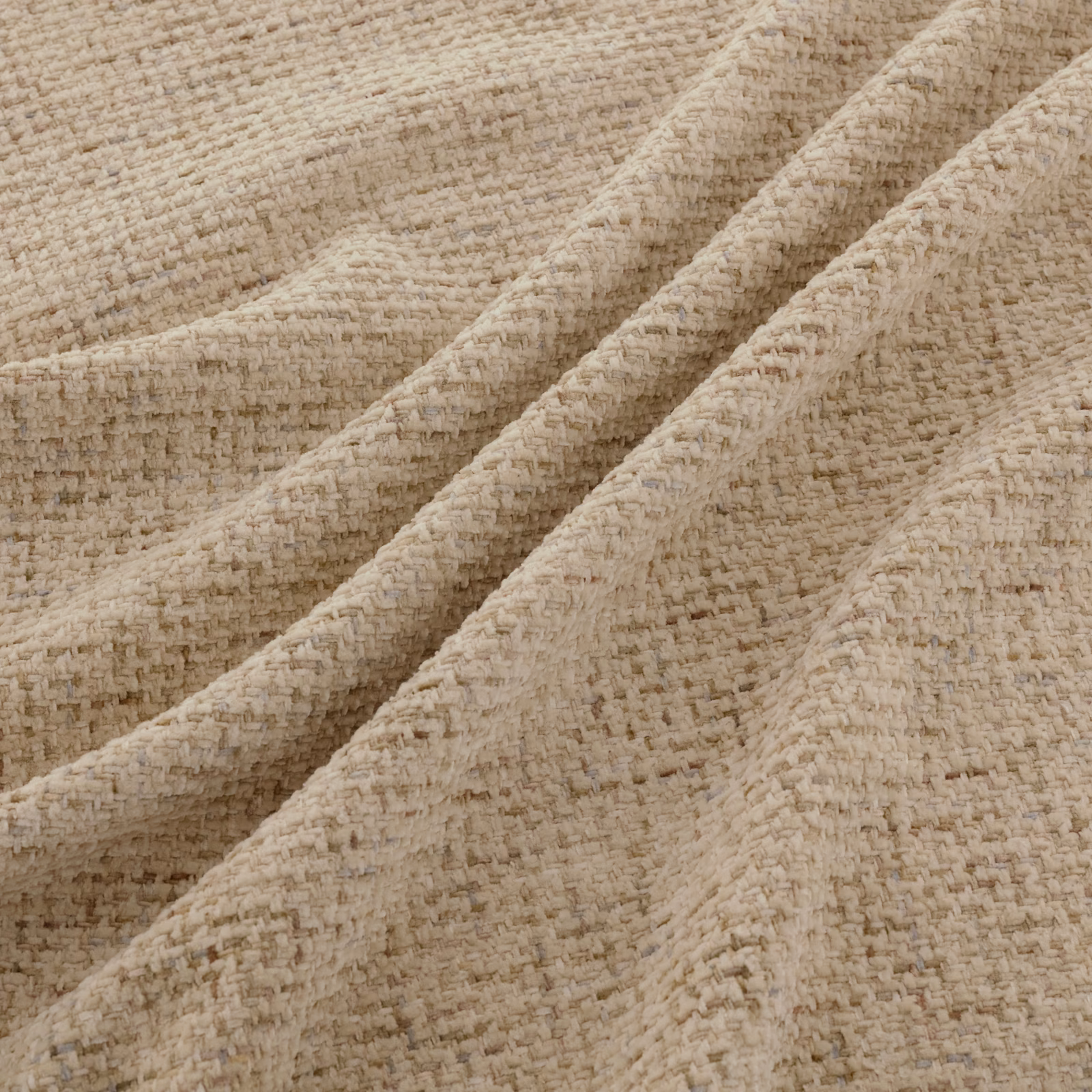 Warm cream Tribeca fabric showing nubby woven texture in soft folded layers