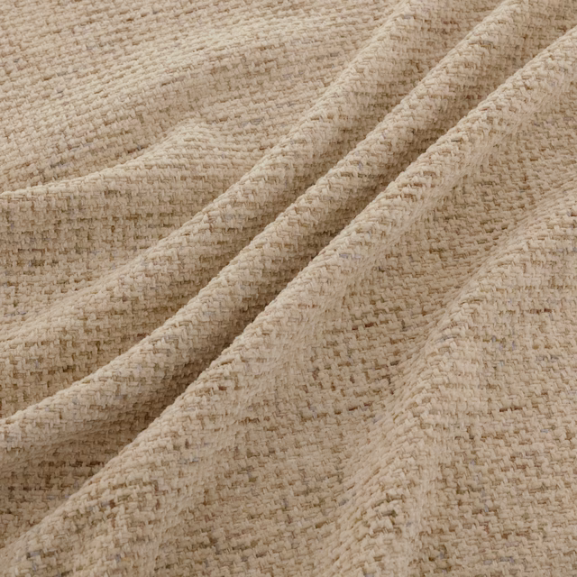 Warm cream Tribeca fabric showing nubby woven texture in soft folded layers