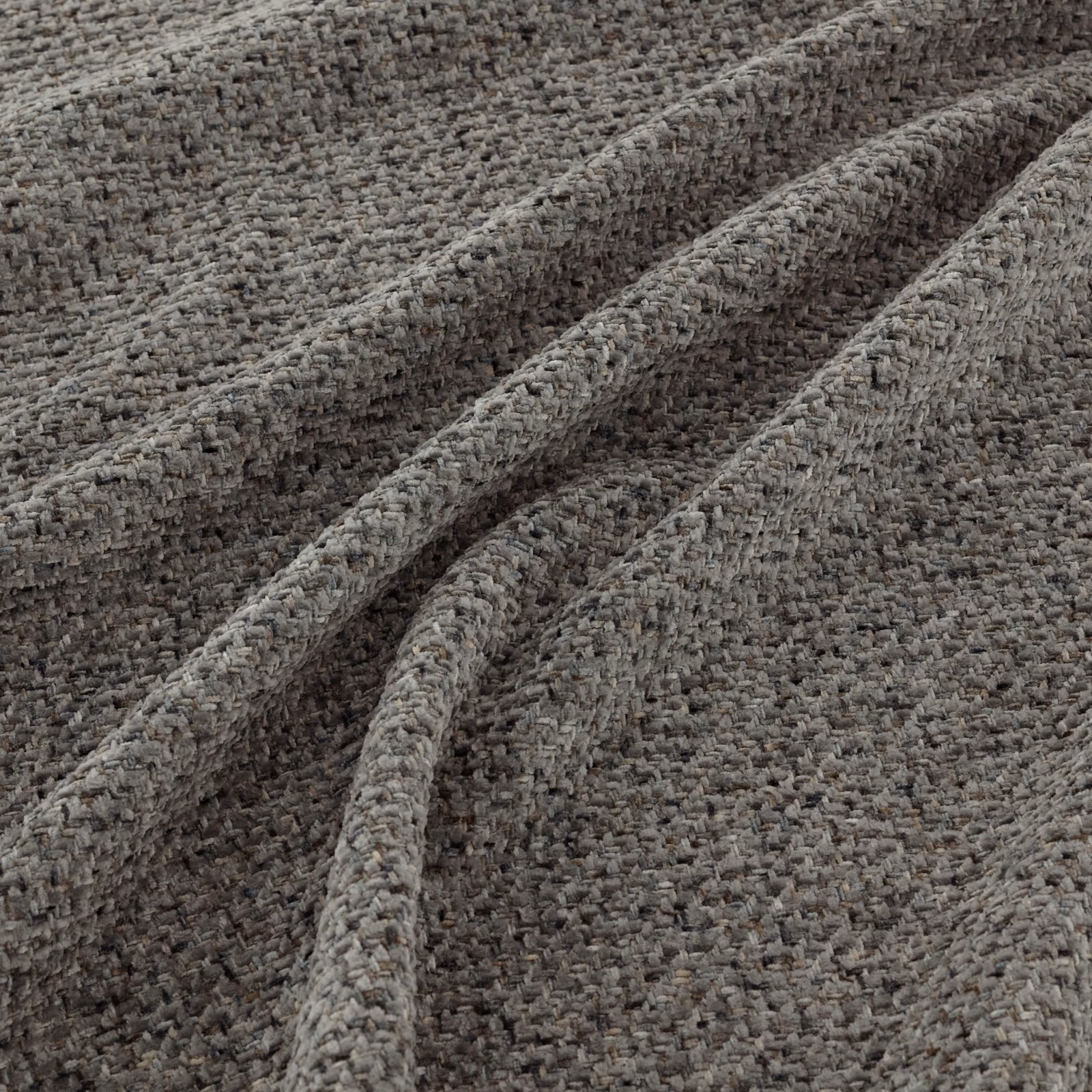 Close-up of mottled granite-grey fabric with chunky nubby woven texture and folded ridges
