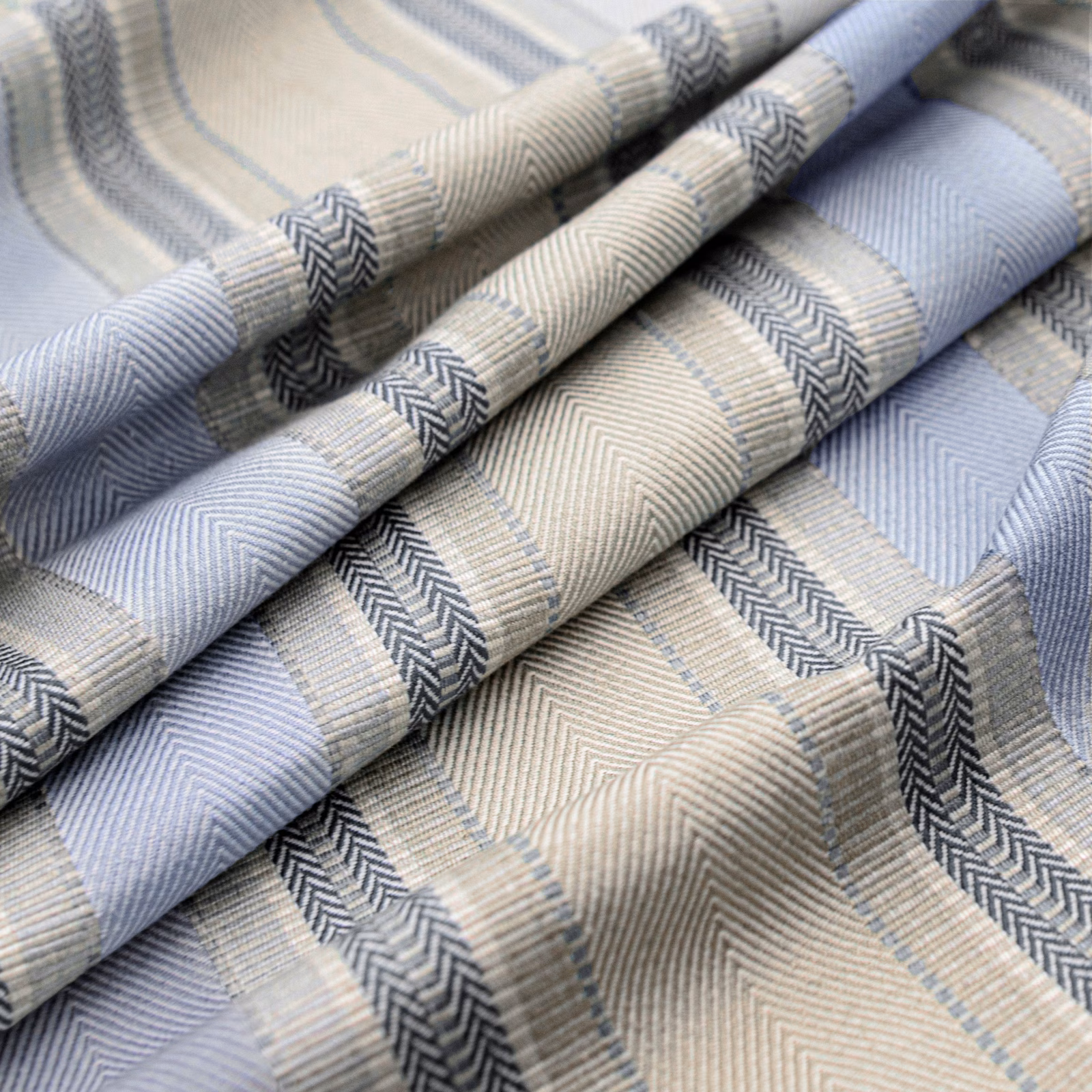 Cream and pale blue woven fabric with charcoal chevron bands and herringbone texture