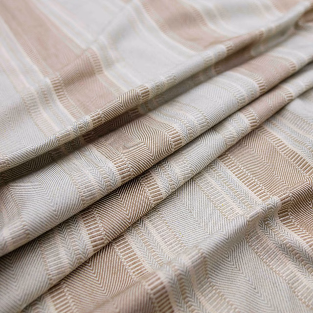 Pale taupe and ivory chevron-weave fabric folded into layered swatches