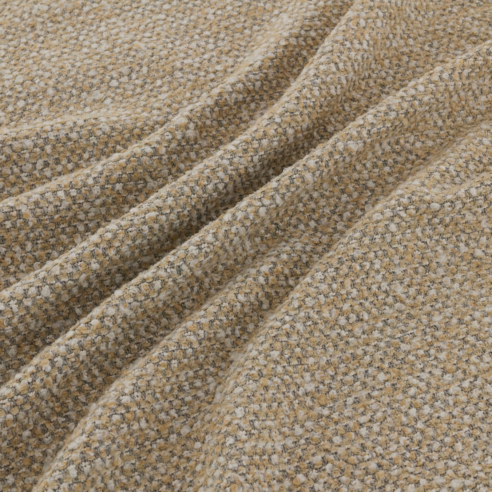 Warm alpaca-beige boucle weave with cream and taupe flecks in gathered folds