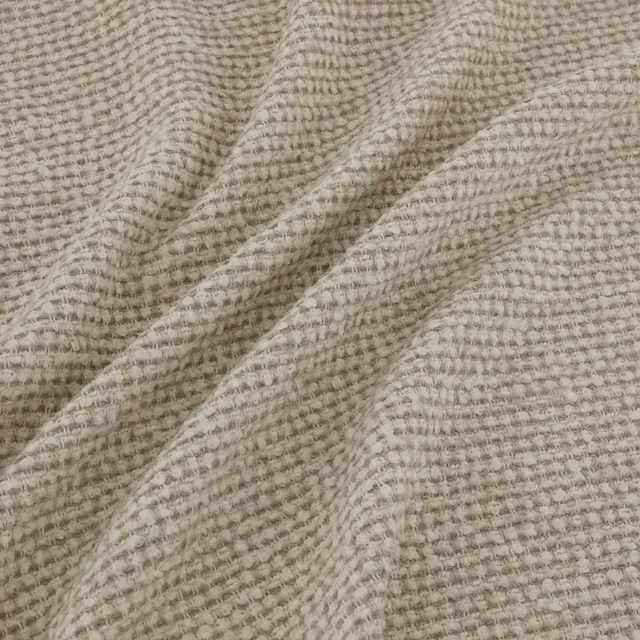 Warm greige taupe fabric with raised nubby tufted weave and soft tonal ridges