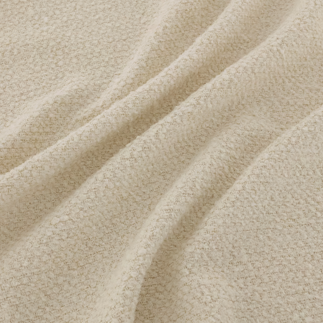 Warm ivory cream Tufty fabric with dense nubby loops folded into soft textured ridges