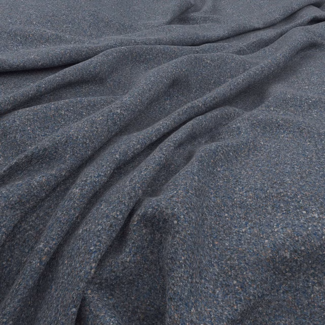 Close view of dark blue-grey tweed weave with fine flecks and soft folds