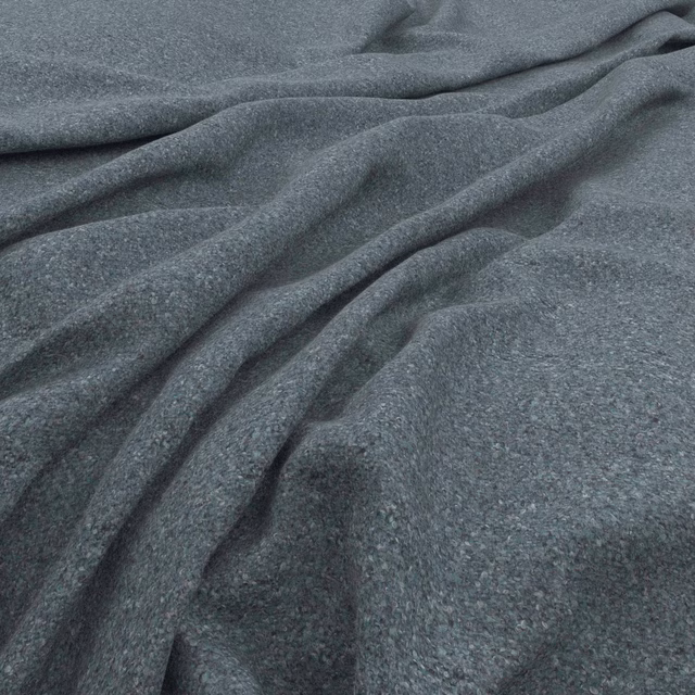 Close-up of cool slate blue-grey tweed with fine flecks and soft folded texture