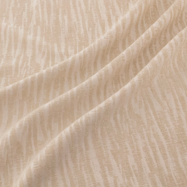 Warm ivory fabric with irregular vertical cream striations falling in soft diagonal folds