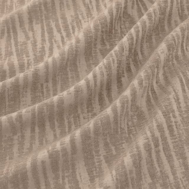 Folded platinum-taupe textile with irregular vertical striations and softly textured surface