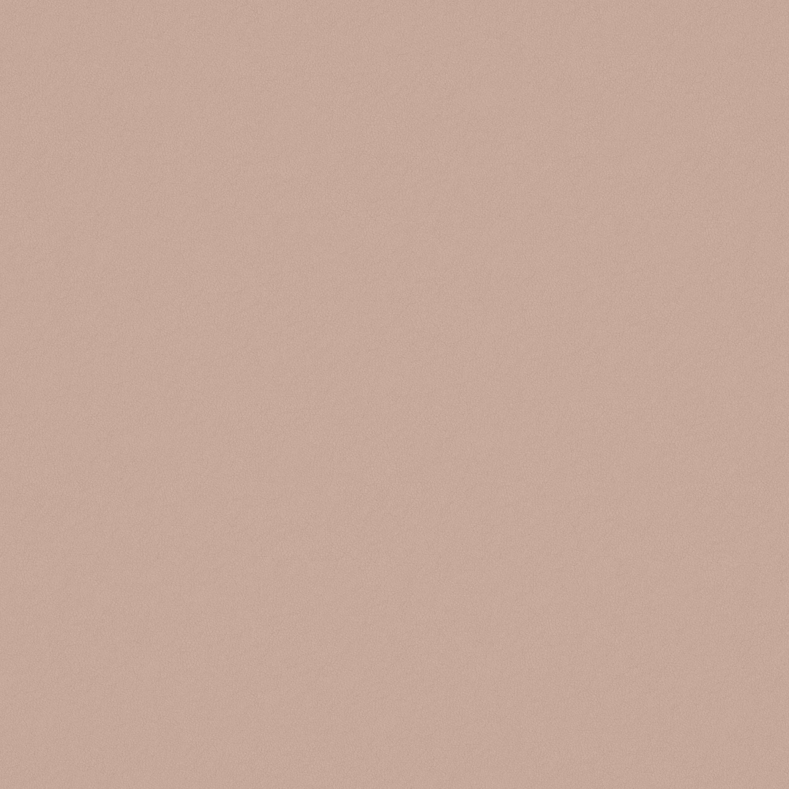 Close-up of softly textured plain fabric in muted dusty blush pink