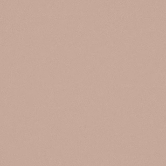 Close-up of softly textured plain fabric in muted dusty blush pink