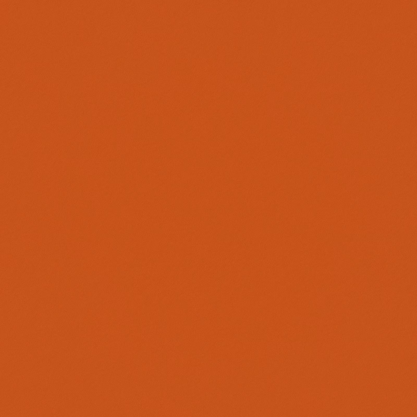 Close-up of solid saturated tangerine-orange fabric with a subtle textured surface