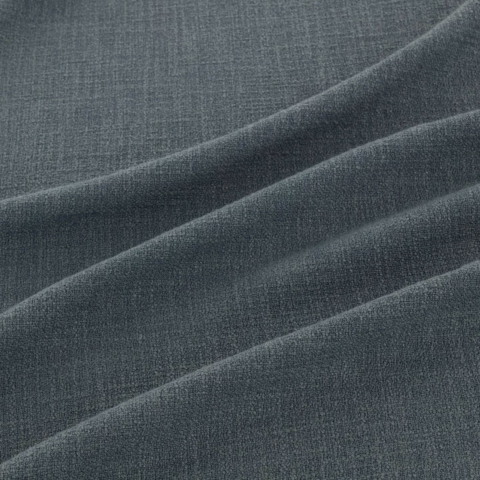 Deep slate-blue finely woven fabric folded to show subtle tonal highlights