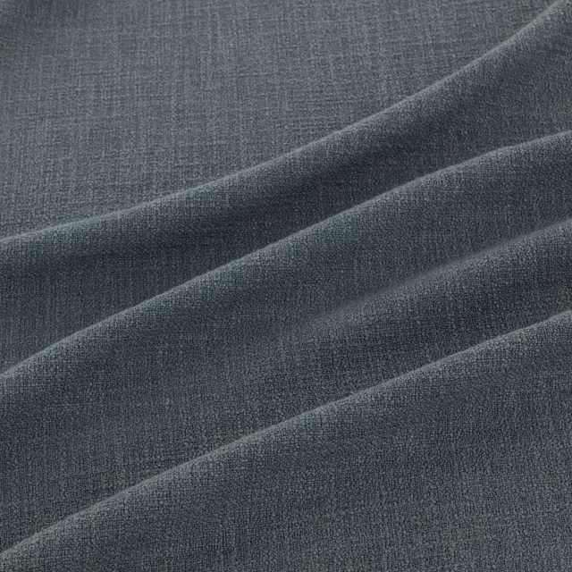 Deep slate-blue finely woven fabric folded to show subtle tonal highlights