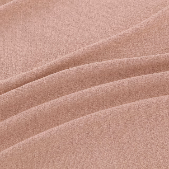 Dusty blush-pink fine weave falling in broad, softly layered folds