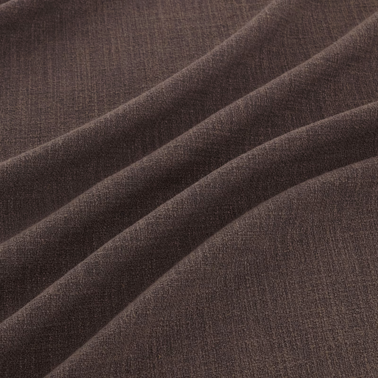 Deep cocoa-brown woven fabric with subtle grain in broad diagonal folds