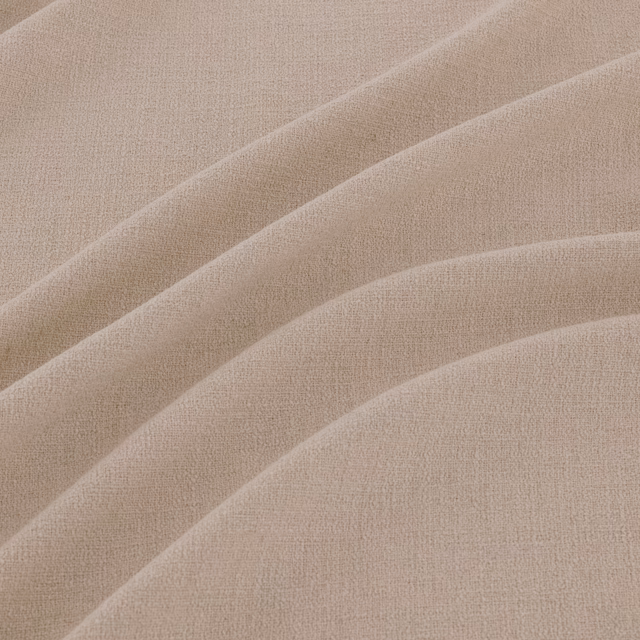 Close-up of pale greige-beige plain weave with softly shadowed flowing folds