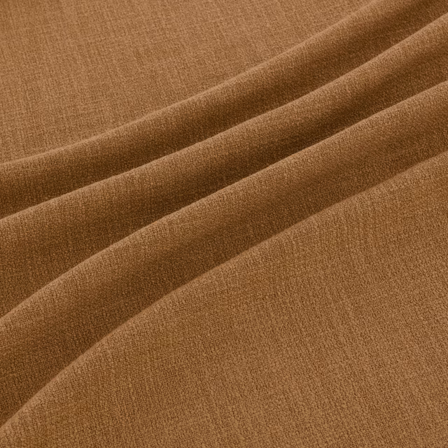 Warm ochre-brown woven fabric showing fine texture and softly shaded folds