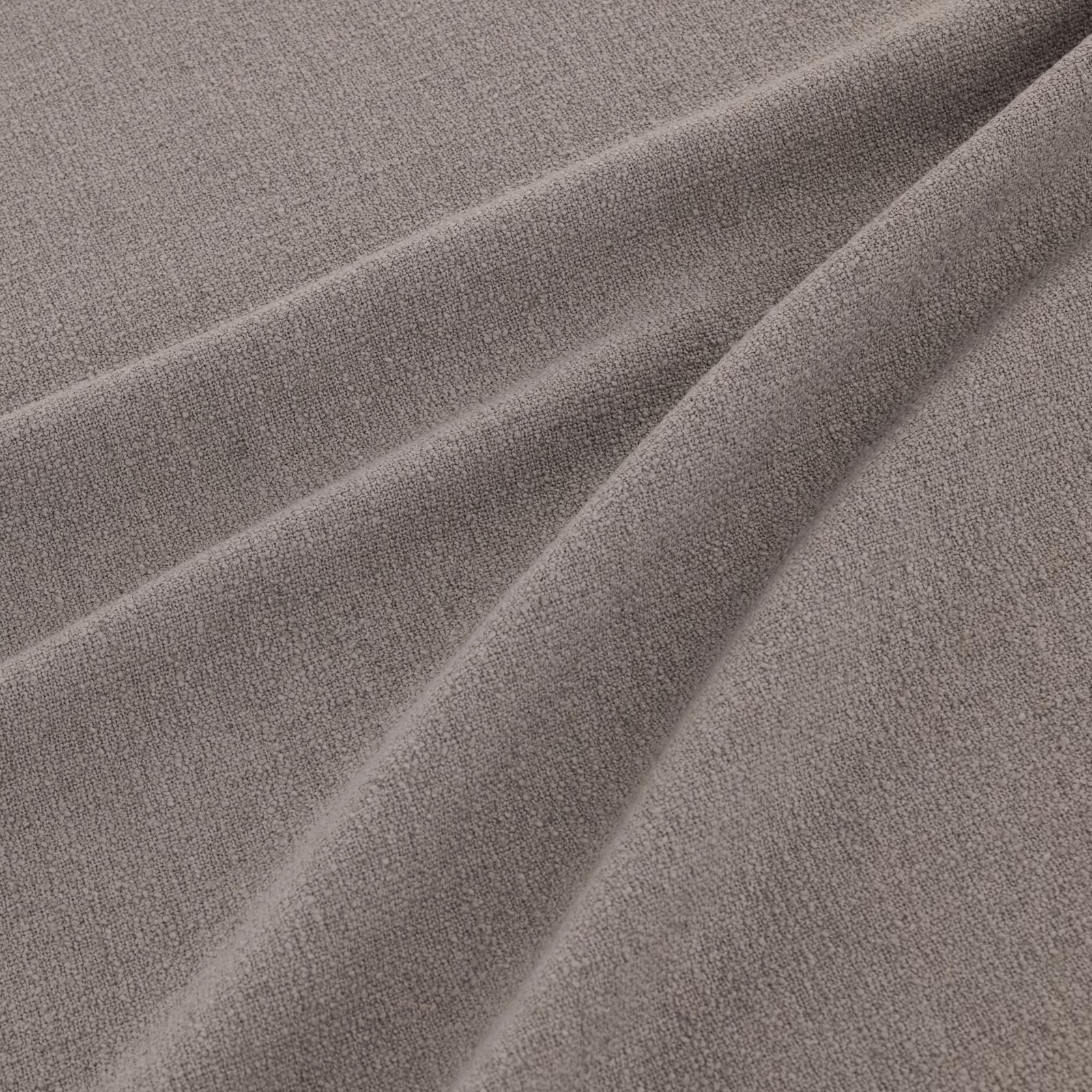 Warm powder-taupe woven fabric shown in soft, flowing folds with subtle grain