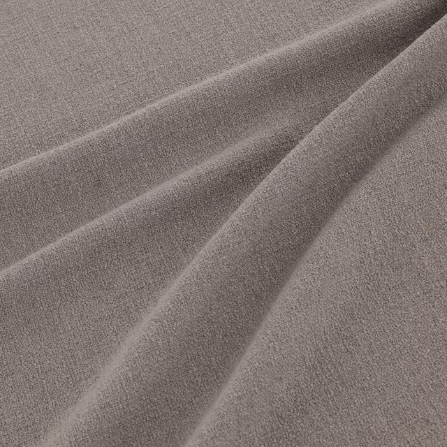 Warm powder-taupe woven fabric shown in soft, flowing folds with subtle grain