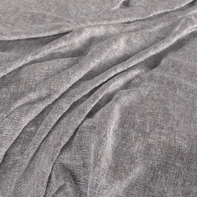 Cloud-grey fabric with fine crosshatch texture folding into soft silver highlights