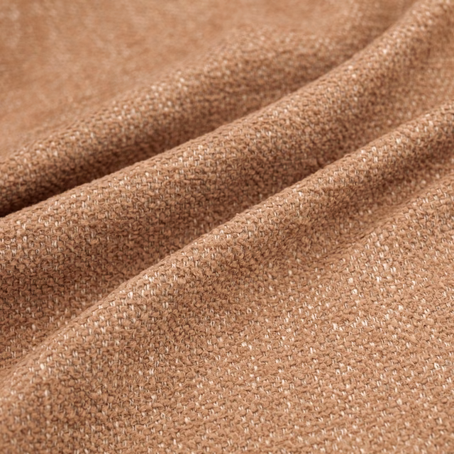 Warm clay-brown woven fabric with pale flecks, shown in deep soft folds