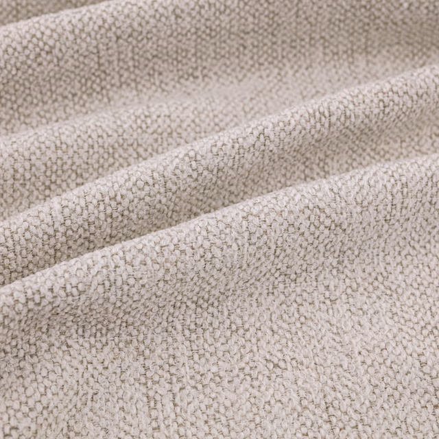 Warm ecru woven fabric with irregular raised pebble texture and soft folded ridges