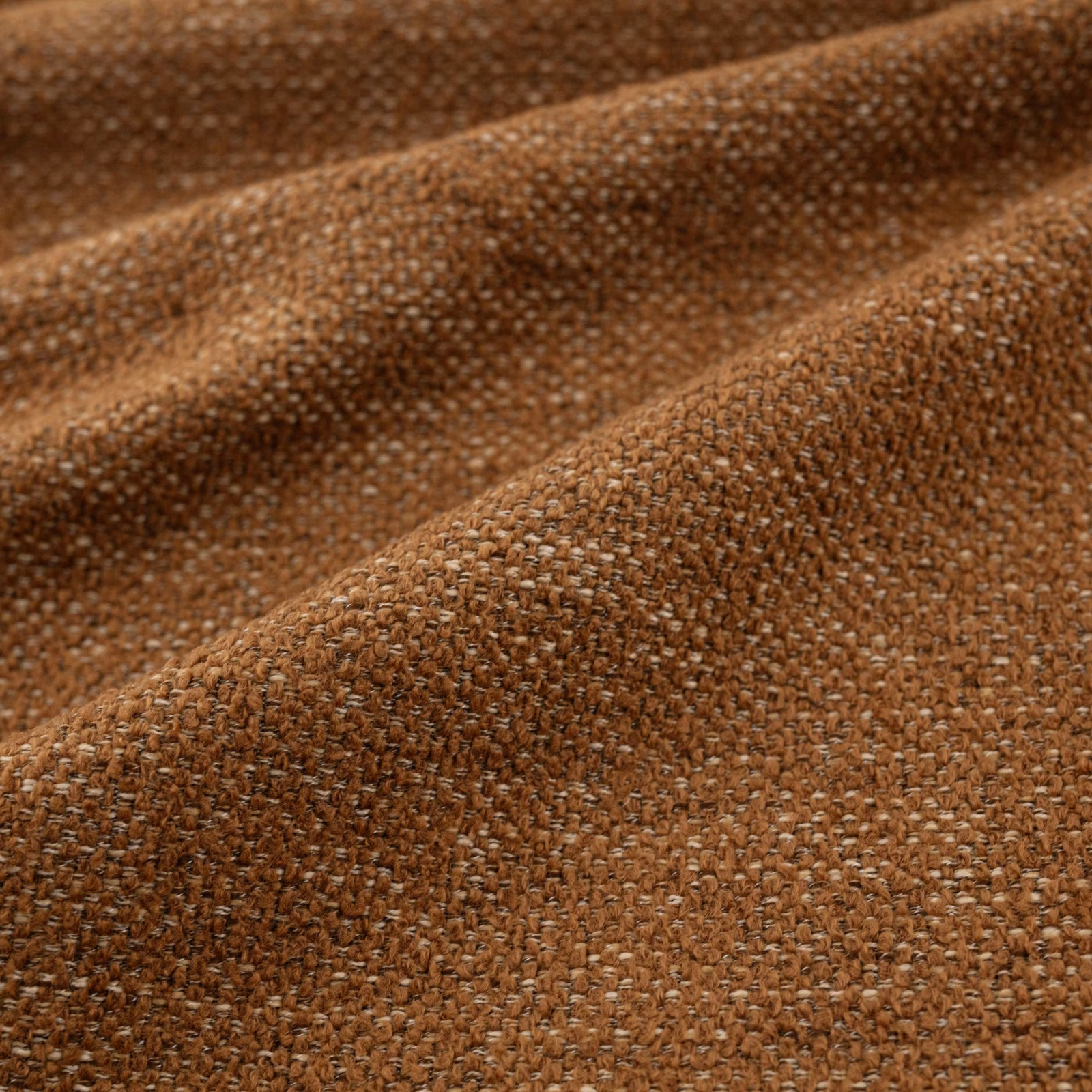 Warm kiln-brown chunky weave with flecked yarn texture in close-up
