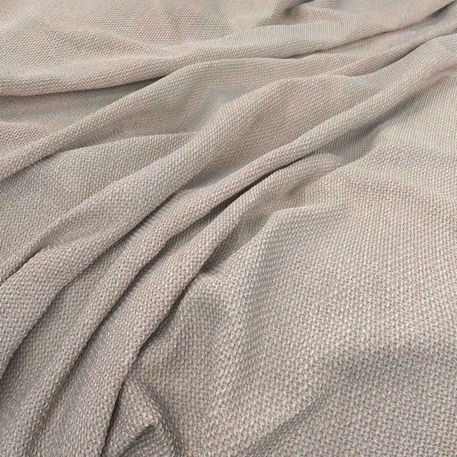 Pale greige woven cloth gathered into soft folds, showing a fine pebbled texture