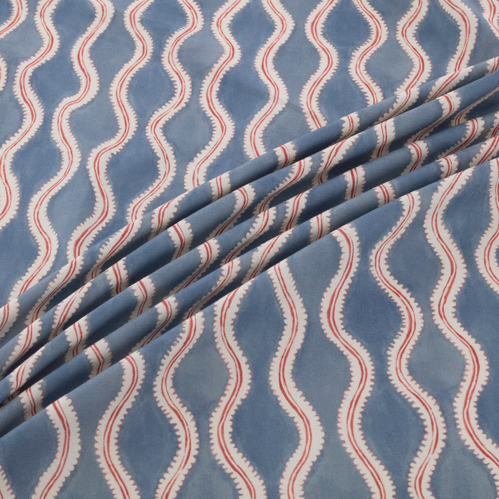 Dusty blue fabric with cream serpentine bands and fine red edge detailing
