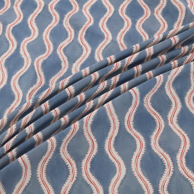 Dusty blue fabric with cream serpentine bands and fine red edge detailing