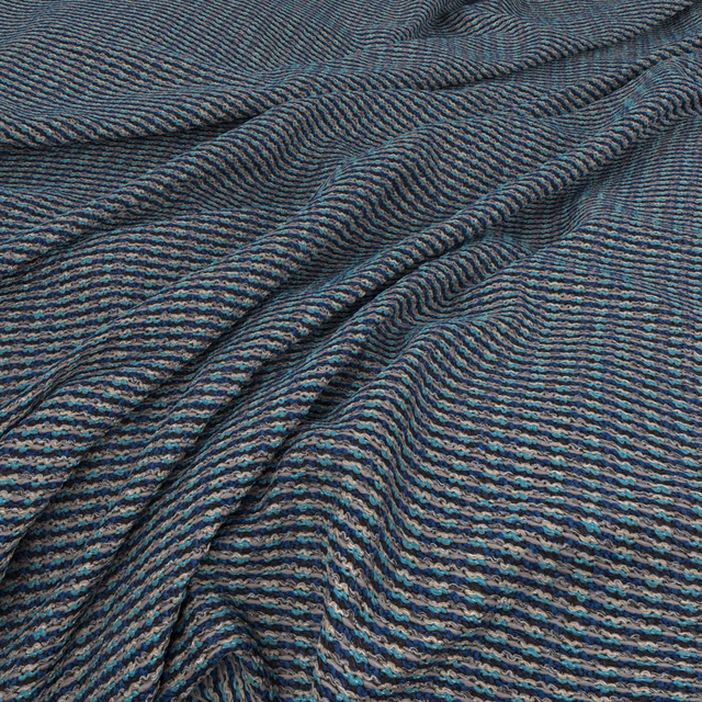 Close view of dark blue-teal Waffle Marina with rippled charcoal-striped texture