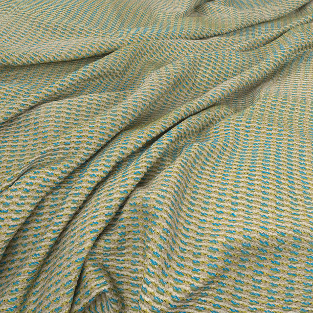 Sandy beige waffle weave with turquoise flecks and softly folded texture