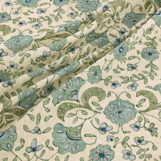 Ivory floral fabric with sage vines and muted blue-green flowers in soft folds