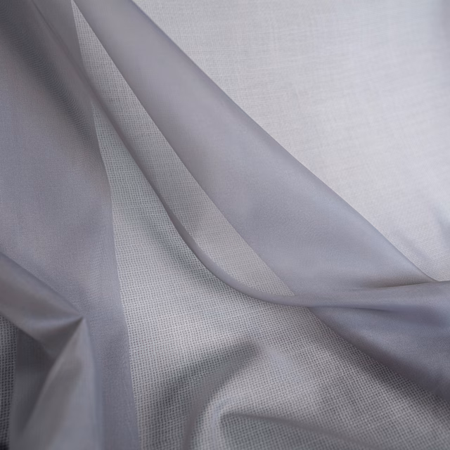 Pale cool-lilac fabric in fluid folds over a fine open grid weave