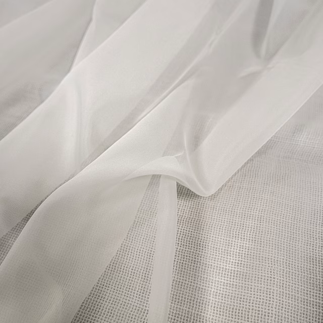 Translucent ivory-white sheer fabric draped in soft folds over a fine grid weave