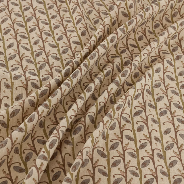 Warm beige fabric with taupe-brown leafy vines shown in soft folded pleats