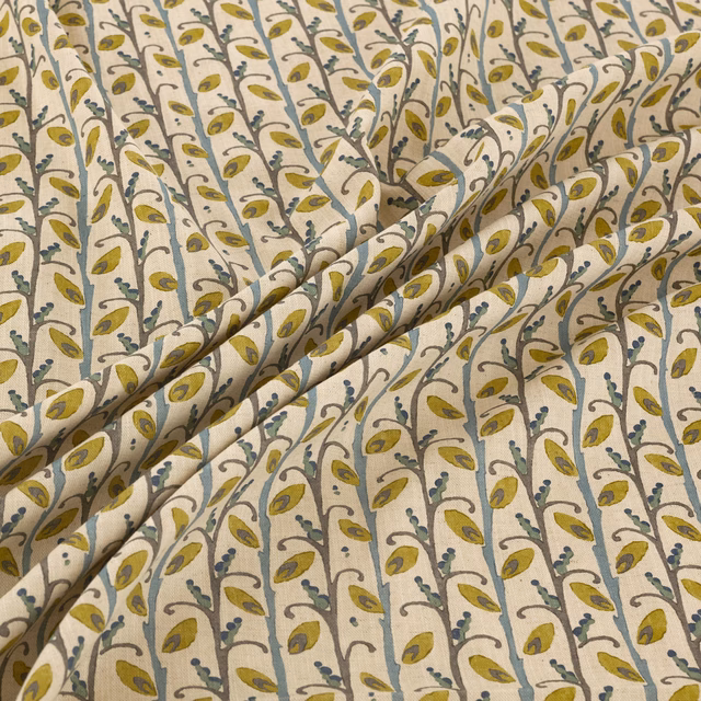 Cream fabric with olive leaves and blue-grey trailing vines in soft folds