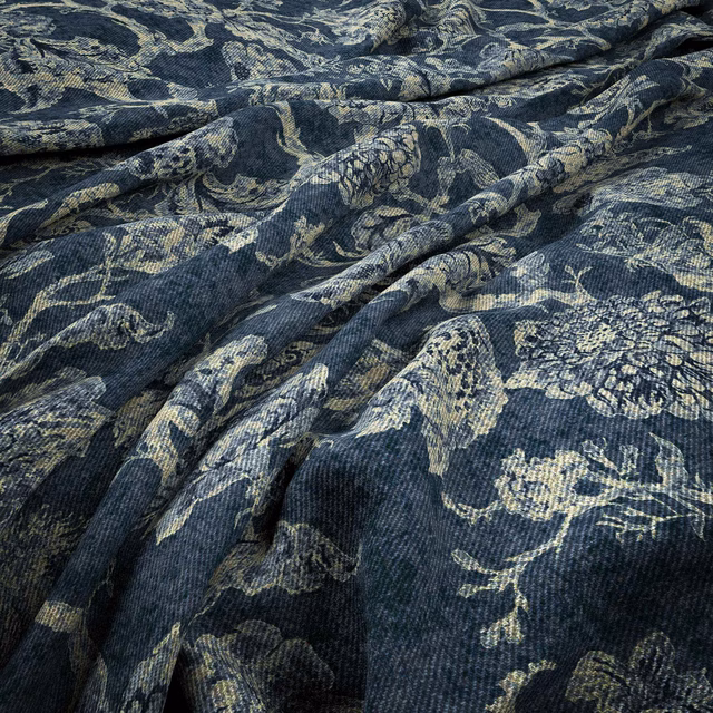 Dark indigo botanical fabric with pale blue-grey floral motifs and folded woven texture