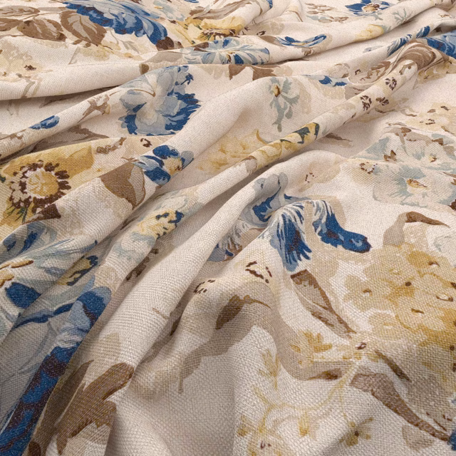 Cream floral fabric with denim-blue blooms, taupe leaves and softly textured weave