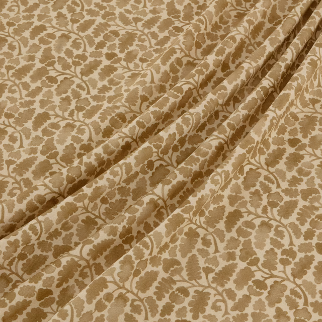 Warm beige textile with taupe-brown floral vines, leafy motifs and soft folds