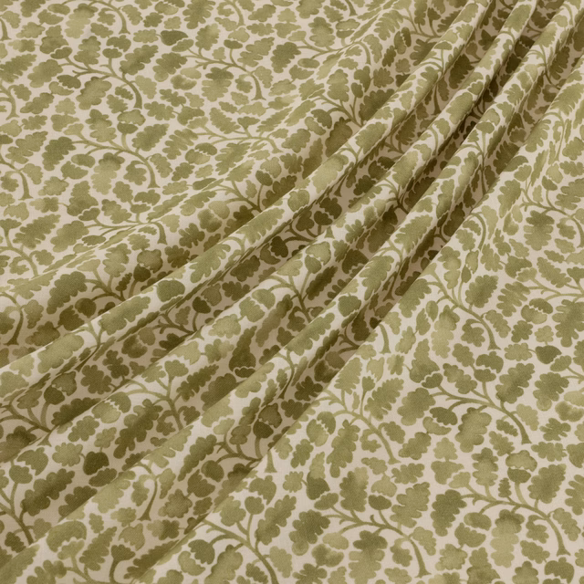 Muted olive leaf trails over a creamy ground, shown in soft diagonal folds