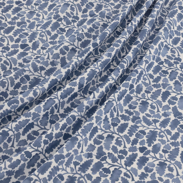 Dusty blue botanical vines and leaves on a pale blue-grey ground
