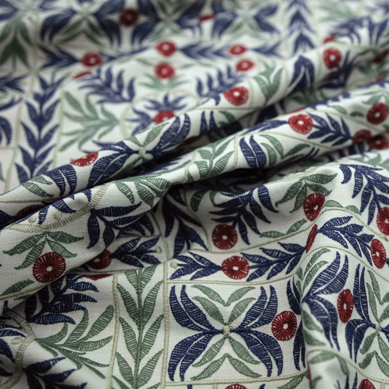 Warm ivory botanical fabric with navy leaves, sage foliage and burgundy flowers