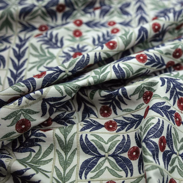 Warm ivory botanical fabric with navy leaves, sage foliage and burgundy flowers