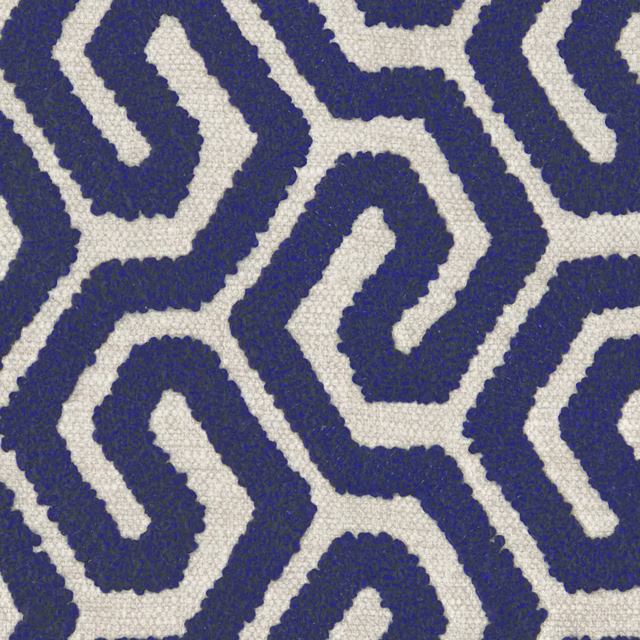 Midnight blue interlocking geometric loops with raised texture on an ivory woven ground