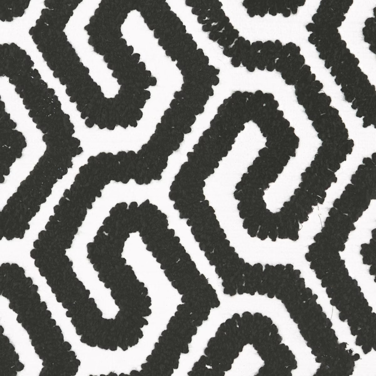 Raised black meandering bands across a white nubby geometric fabric ground