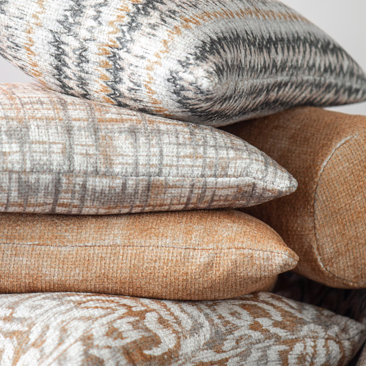 Warm honey-gold woven cushion fabric with tactile crosshatch and soft geometric marks