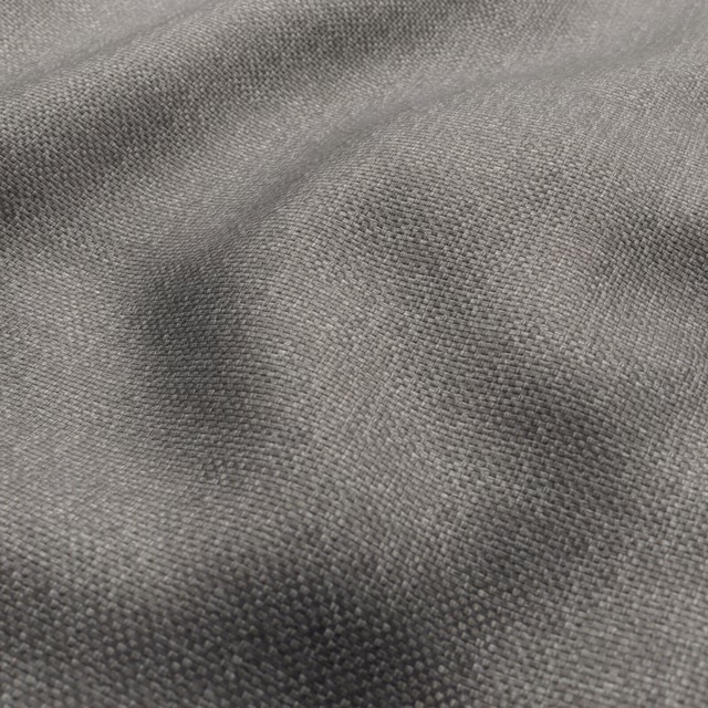 Close-up of warm cappuccino taupe fabric with a fine, softly irregular weave