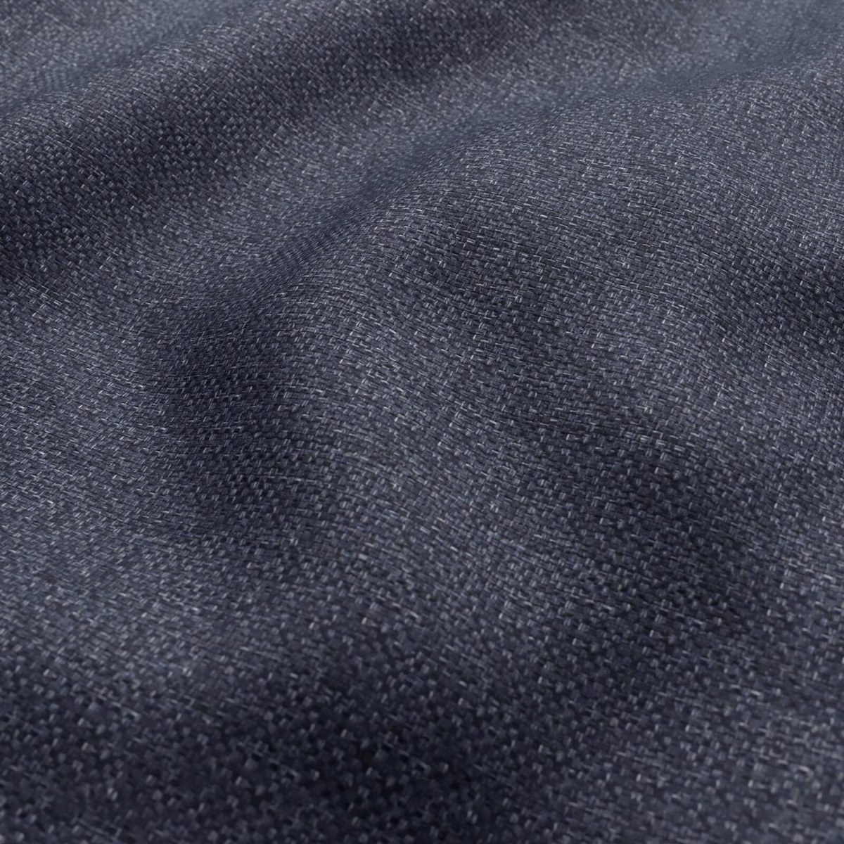 Close-up of dark slate blue-grey woven fabric with mottled charcoal texture